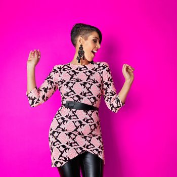 brand portrait of stylist on pink background dancing