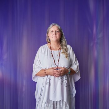brand portrait of counsellor in white outfit against purple background