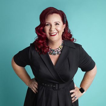 headshot of author with teal background