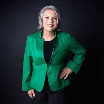 headshot of consultant with green jacket